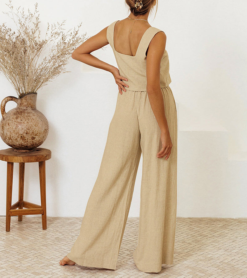 A woman wearing a minimal two-piece set with a square neckline and belted flared trousers.