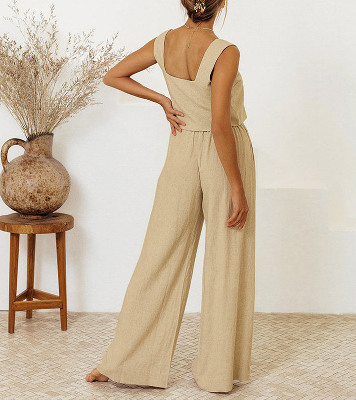 A woman wearing a minimal two-piece set with a square neckline and belted flared trousers.