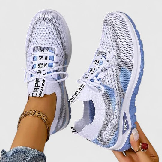 A woman lacing up light, breathable orthopaedic trainers before a walk.