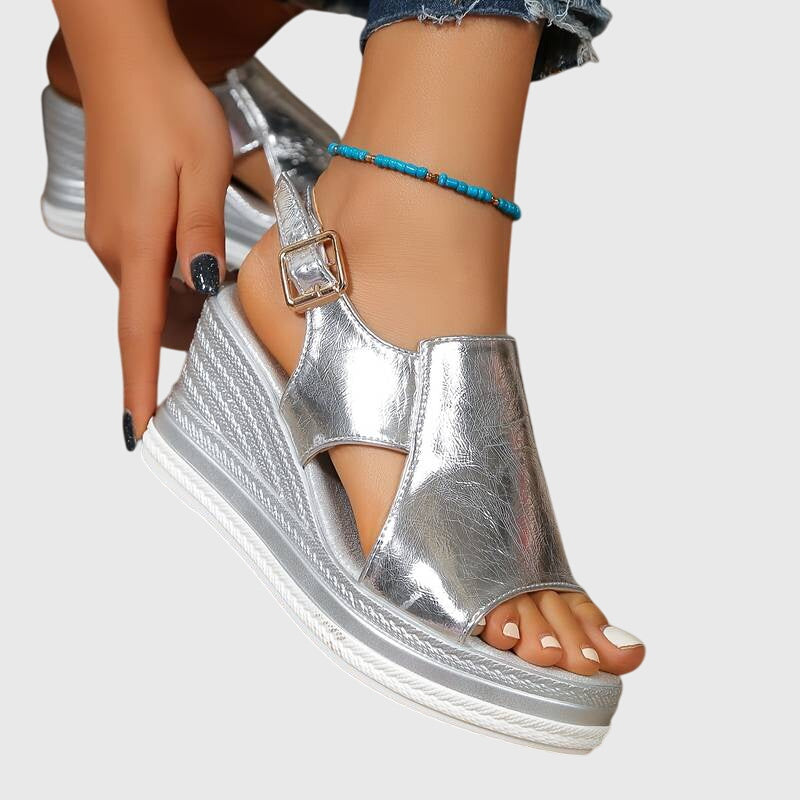 Metallic gold platform sandals with a detailed sole and cushioned footbed