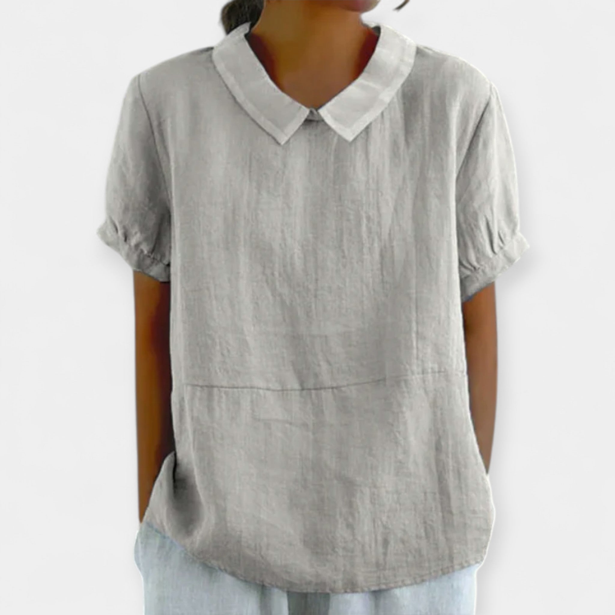 Women's fitted collar-neck top in pale blue with delicate embroidery and button detailing