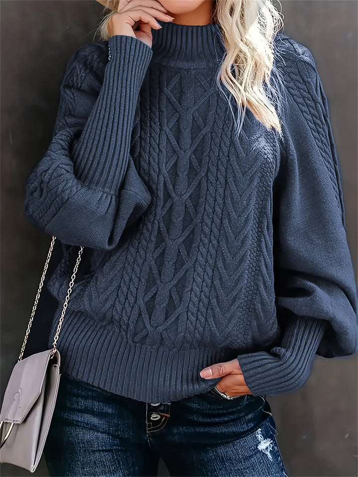 A woman wearing a long, relaxed jumper with long sleeves, soft and cosy for everyday wear.
