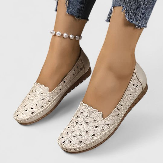 A woman wearing soft open-woven casual sandals on a warm, sunny day.