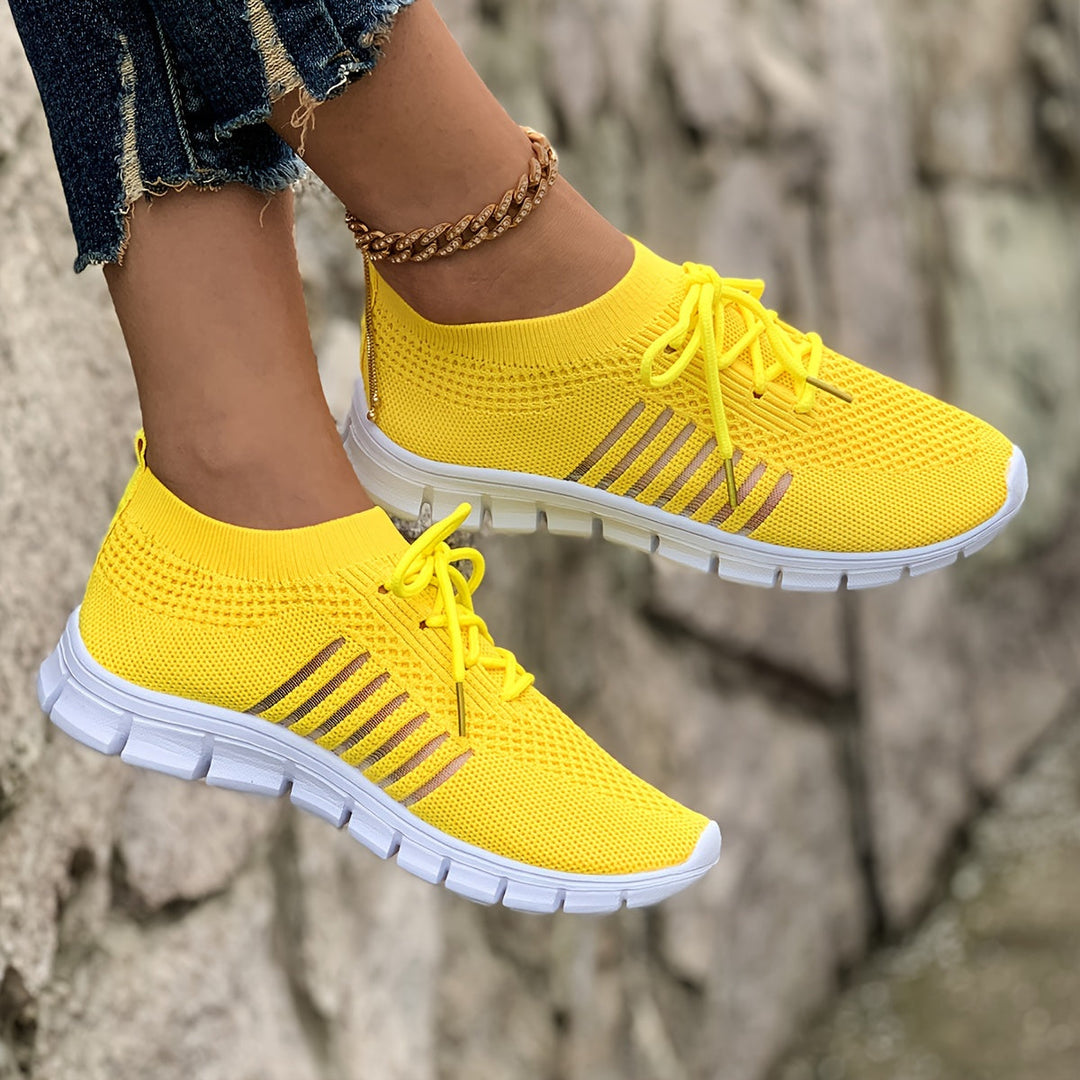 A woman wearing light breathable sock-style comfort shoes