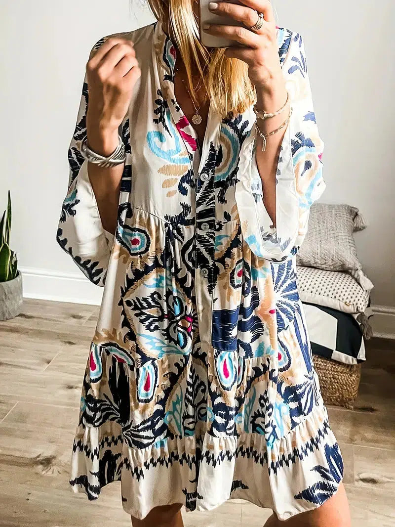 A woman wearing a relaxed boho print tunic dress on a warm, sunny day.