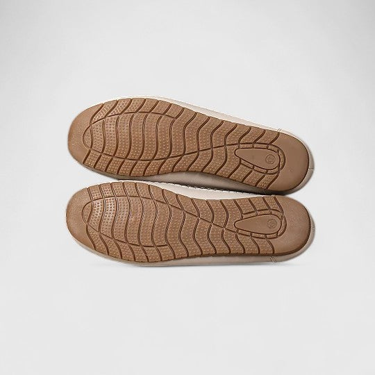 A woman wearing soft open-woven casual sandals on a warm, sunny day.