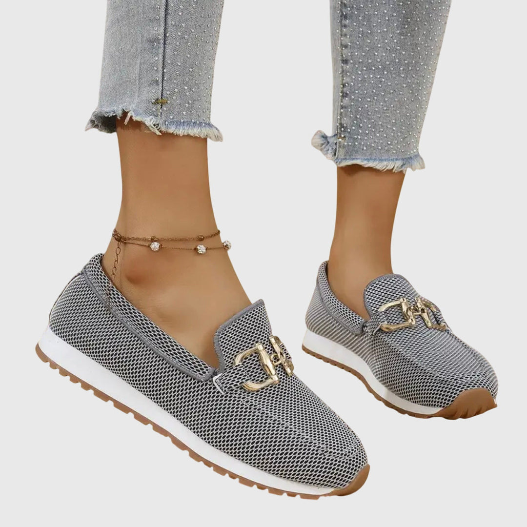 Women's beige comfort slip-on trainers with a cushioned sole and elegant metallic detail