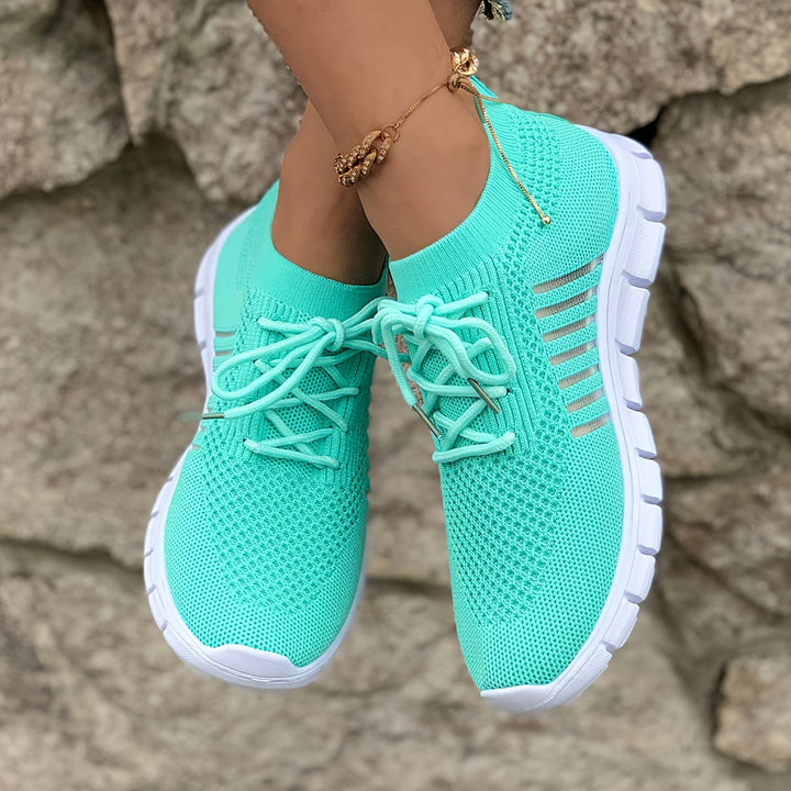 A woman wearing light breathable sock-style comfort shoes