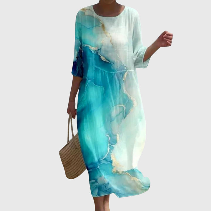 Woman wearing a long flowing maxi dress with a delicate floral print, moving gracefully.