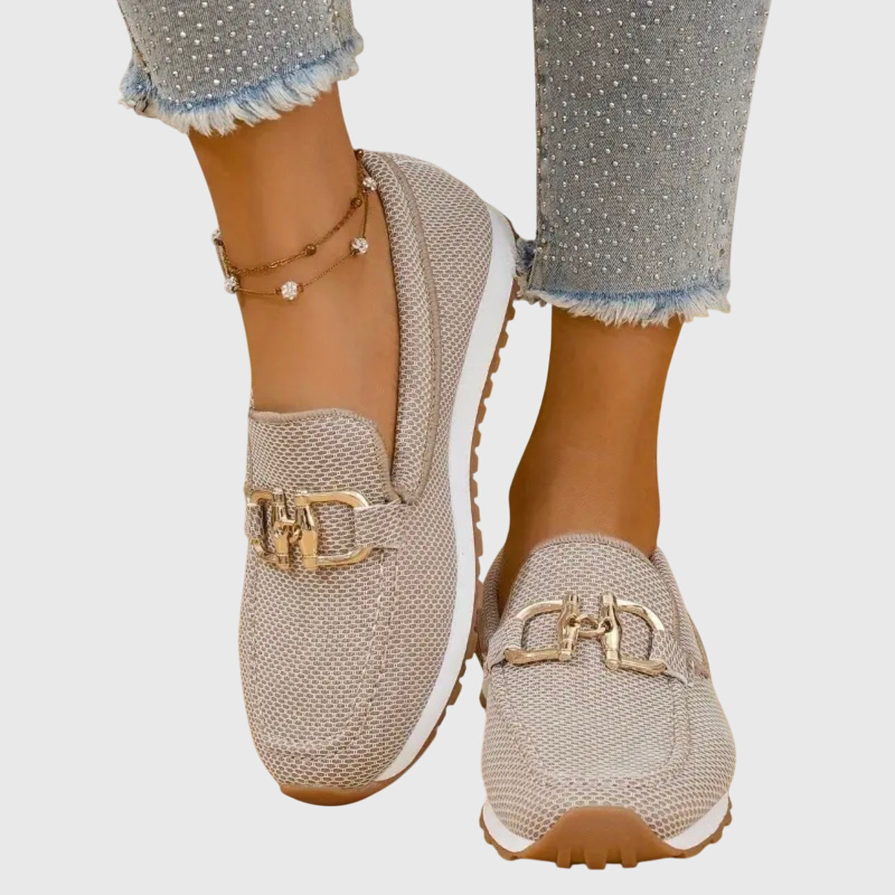 Women's beige comfort slip-on trainers with a cushioned sole and elegant metallic detail