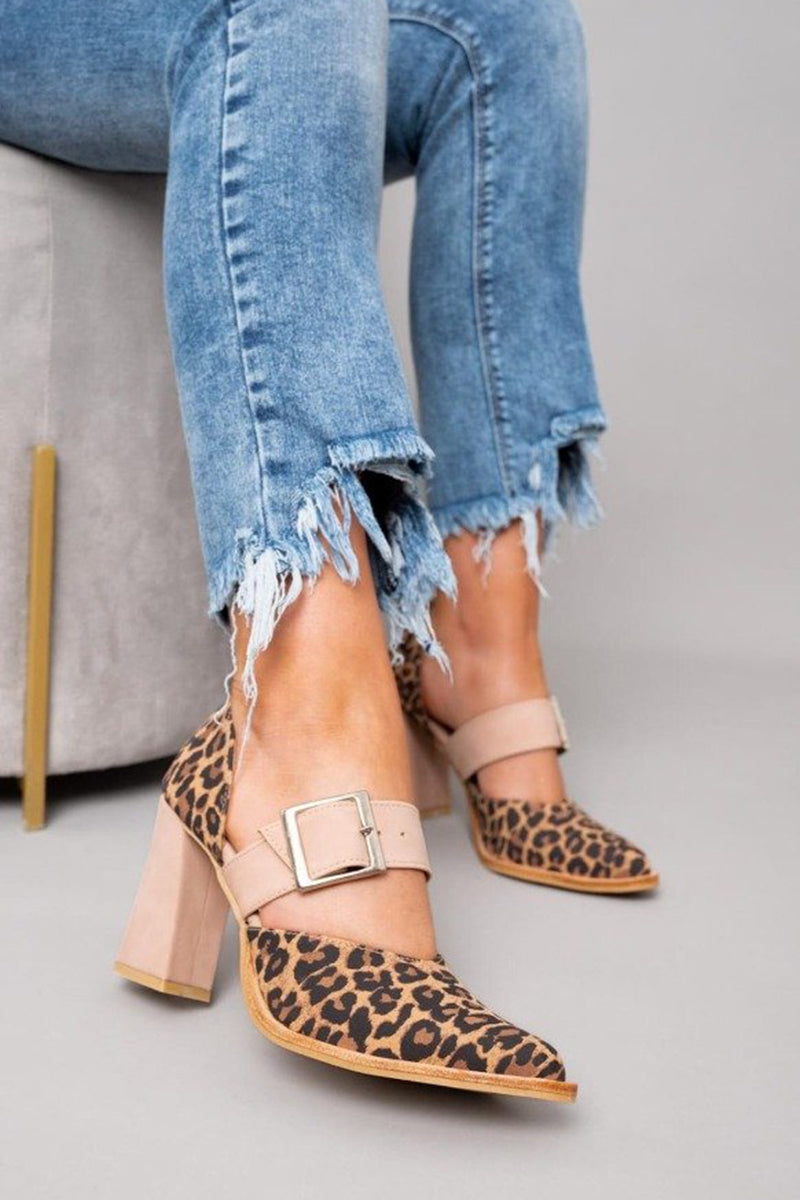 A woman wearing pointed khaki heels, stepping out in a polished day-to-evening outfit.