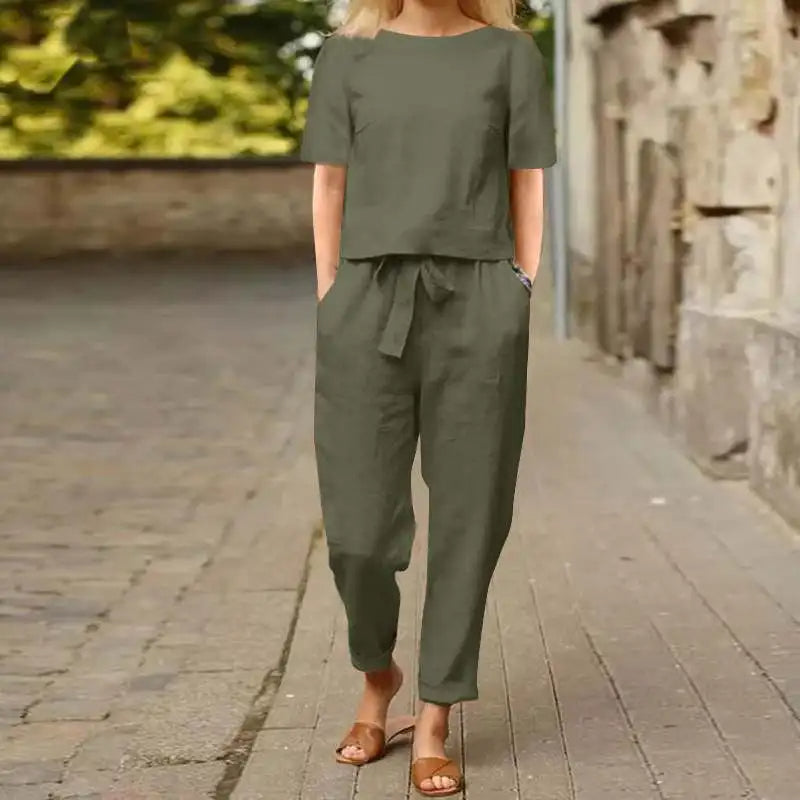 A woman wearing a relaxed short-sleeve top and matching drawstring trousers lounge set.
