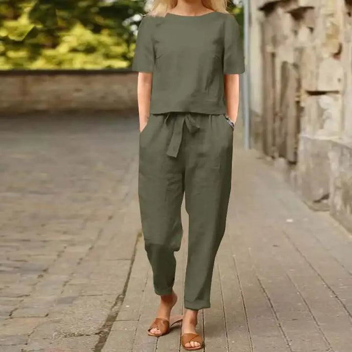 A woman wearing a relaxed short-sleeve top and matching drawstring trousers lounge set.