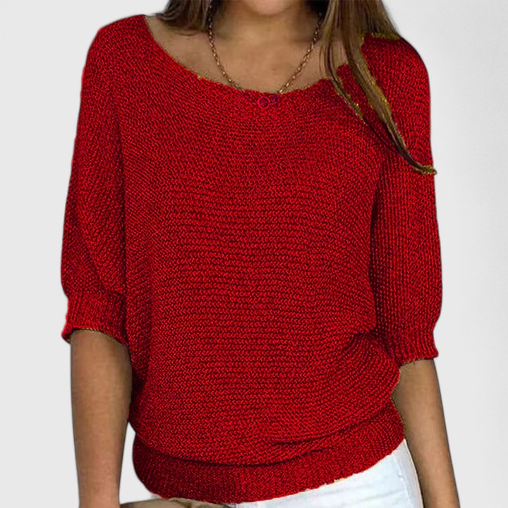 A woman wearing a soft purple jumper with a wide neckline and gently shaped fit.