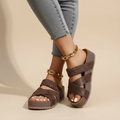 Brown cross-strap wedge sandals with backless design and cushioned sole