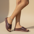 Open-work wedge sandals in bordeaux with a small metallic ornament on the upper