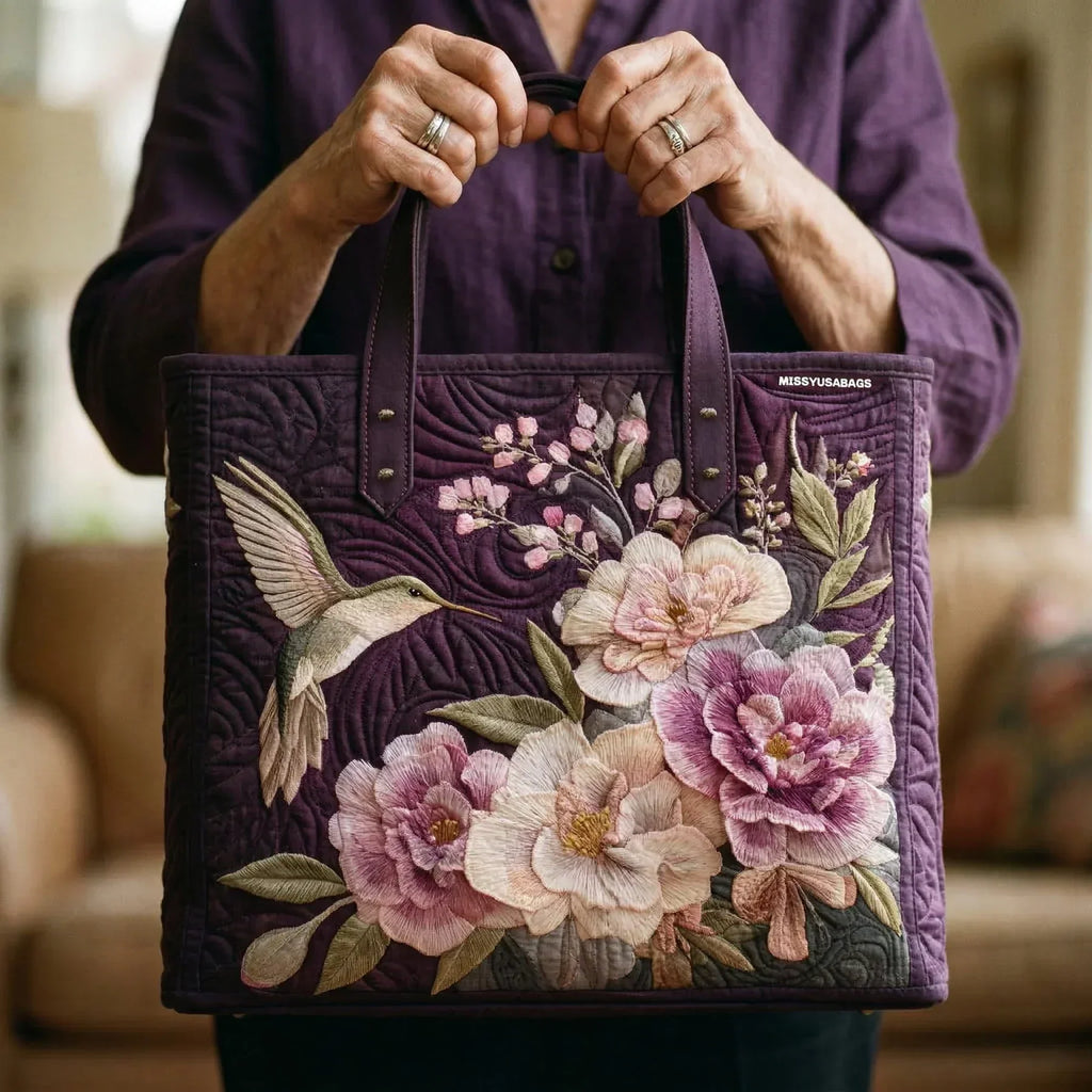 Quilted tote bag with hummingbirds and orchid flowers printed on a wave-stitch body