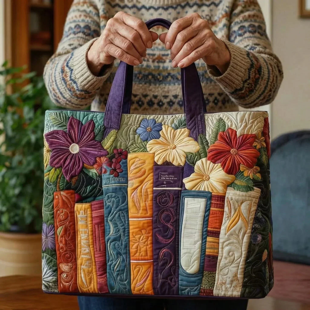 Quilted tote bag with a book lovers motif featuring stacked books and reading scenes on a structured padded body