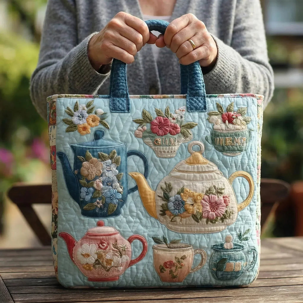 Quilted tote bag with a charming floral and afternoon tea motif on a structured padded body with wave-stitch detail