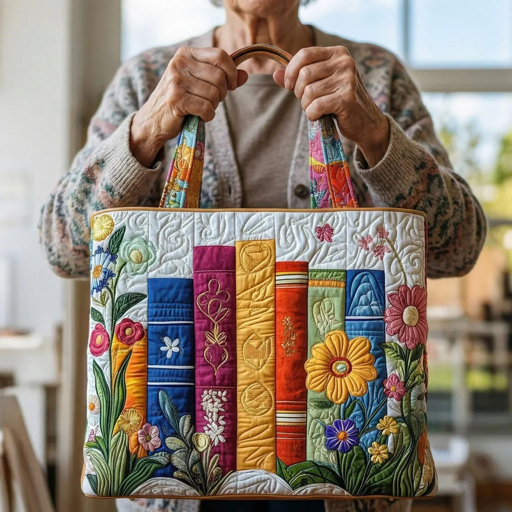 Quilted tote bag with a romantic floral library motif of books and blooms on a padded structured body