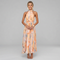 Floaty pastel midi dress with a soft flowing silhouette and warm feminine colour tones