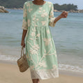 Flowing botanical print midi dress with a soft relaxed silhouette in warm floral tones