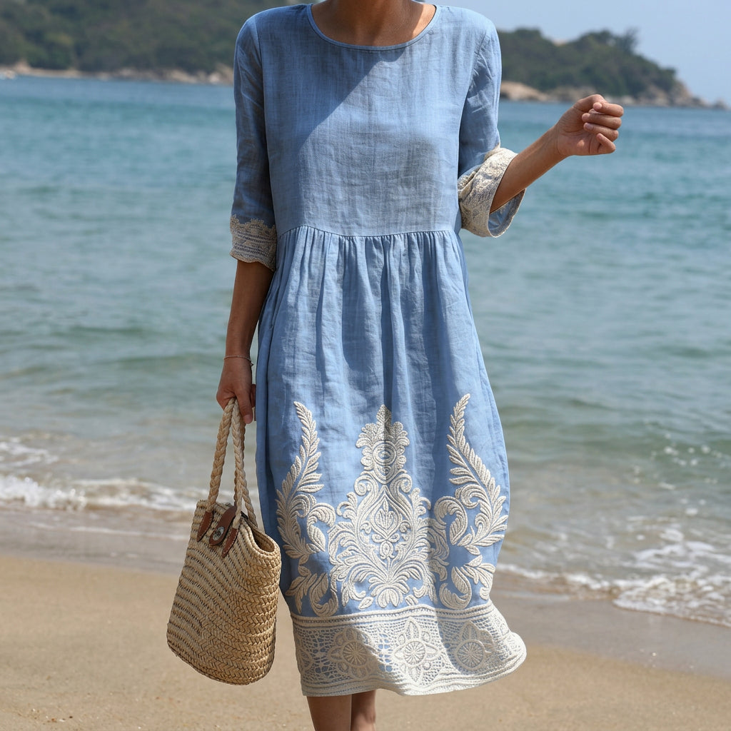 Flowing mid-length dress with a subtle botanical floral print in warm summer tones