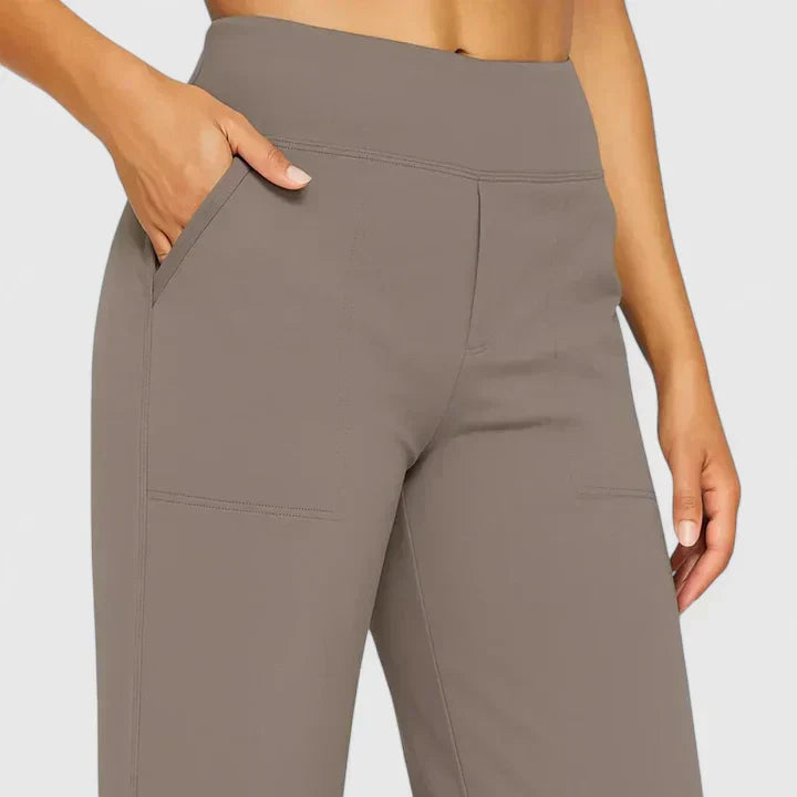 A woman in tailored trousers styled with a simple top for an elegant, comfortable everyday look.
