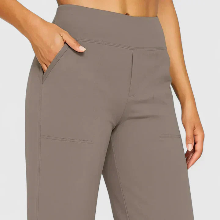 A woman in elegant straight-leg trousers with pockets, styled for a polished everyday look.
