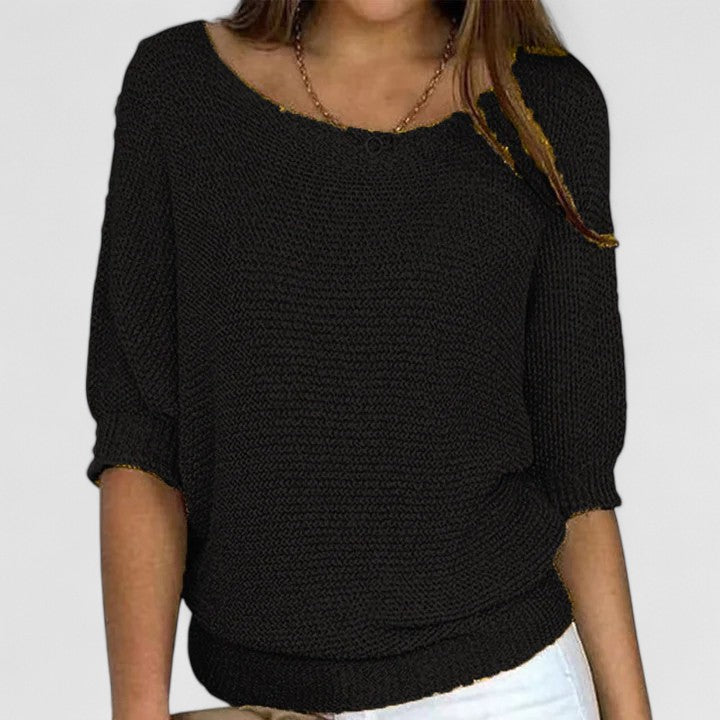 A woman wearing a soft purple jumper with a wide neckline and gently shaped fit.
