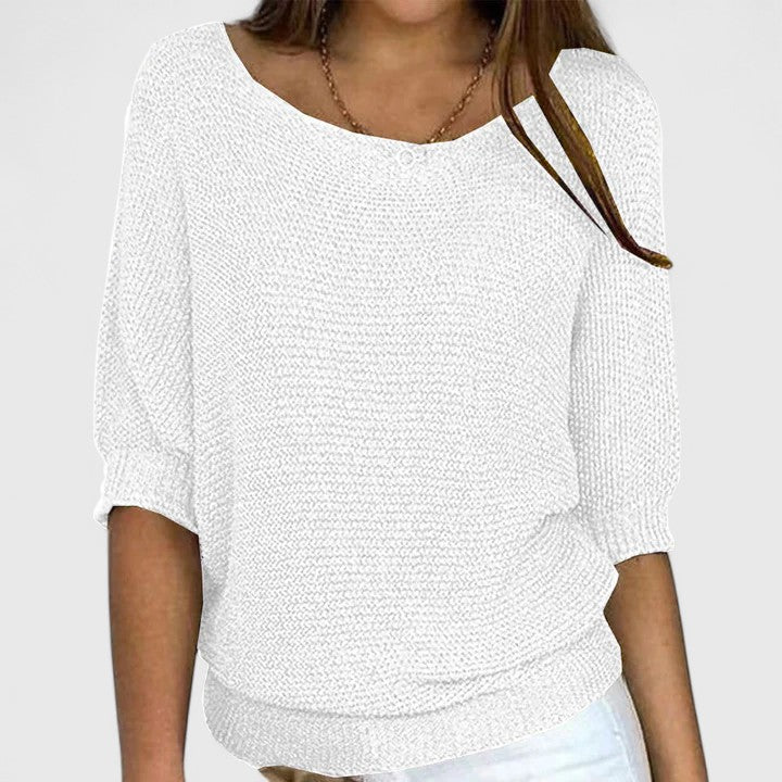 A woman wearing a soft purple jumper with a wide neckline and gently shaped fit.