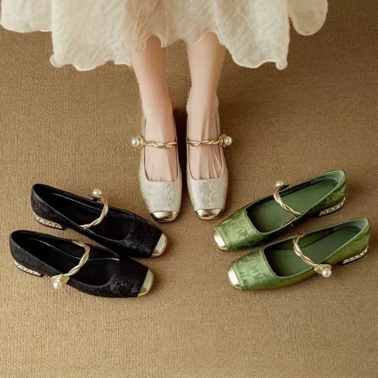 A woman wearing low-heel Mary Janes with a pearl-accented strap and a soft dress
