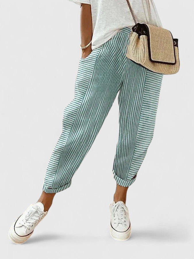 A woman wearing airy comfy summer trousers with an elastic waist and side pockets.
