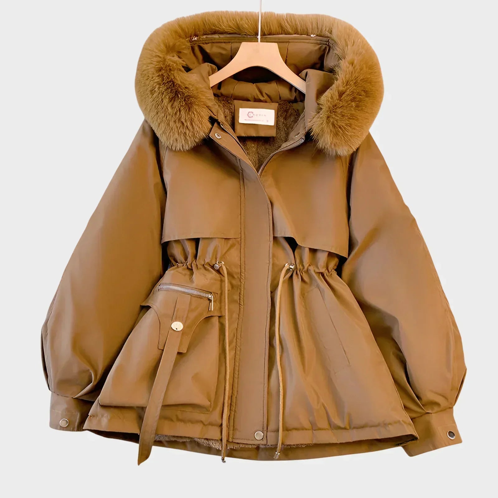 An elegant structured winter coat in camel, styled over a layered winter outfit