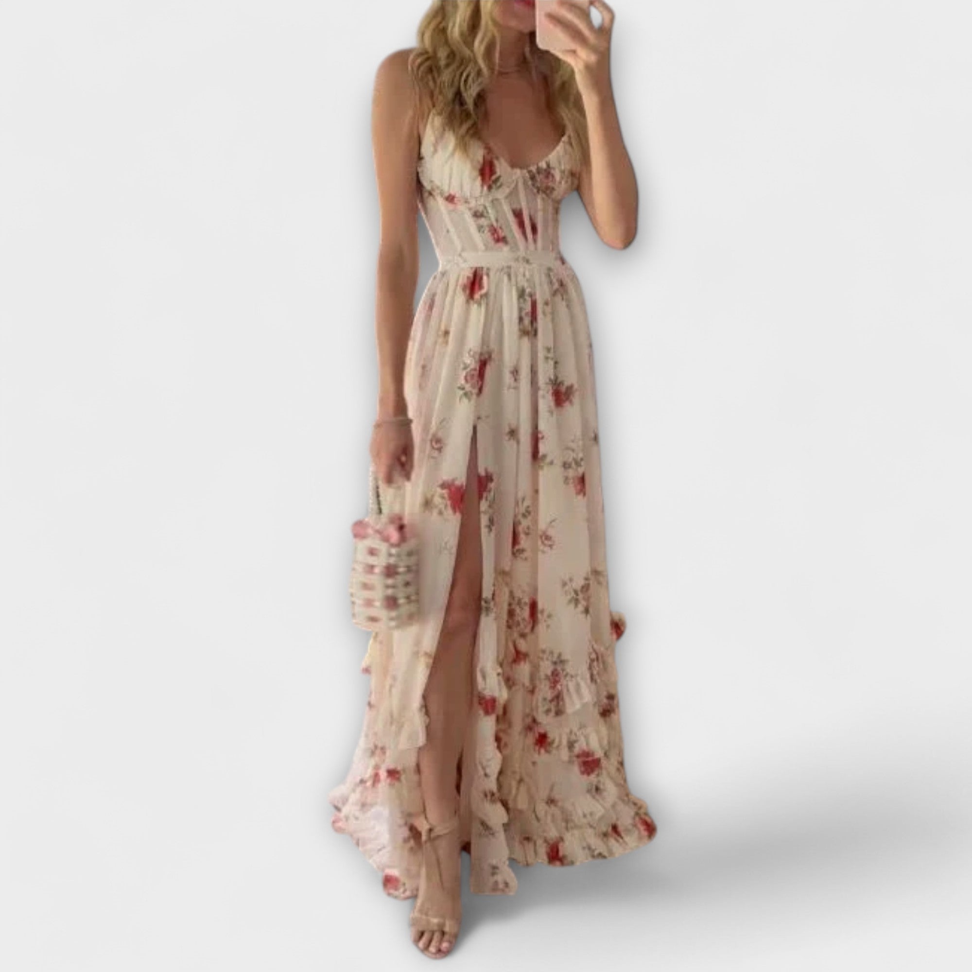A white floral sleeveless fluid dress with a gentle print, styled for a casual summer occasion