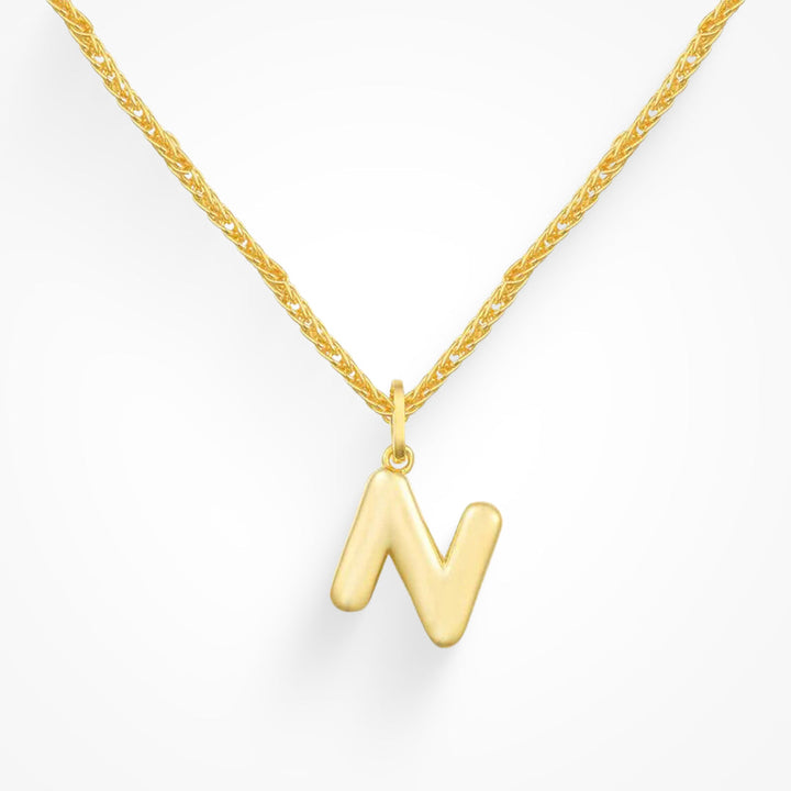 Layering necklace in gold and silver tones displayed on a clean background