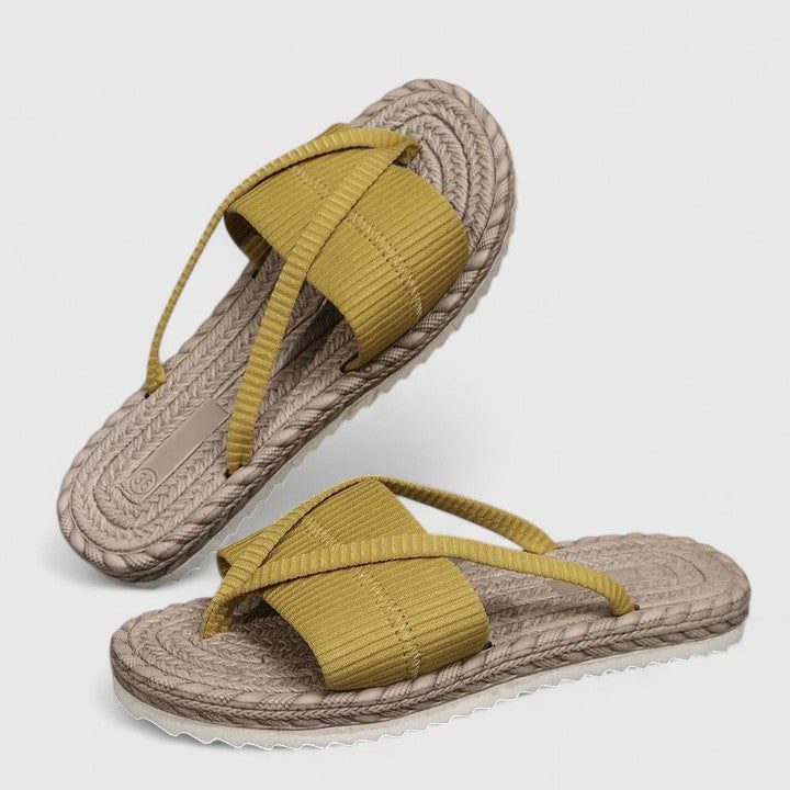 A woman moving freely in wide-fit open-front support sandals with a cushioned footbed.