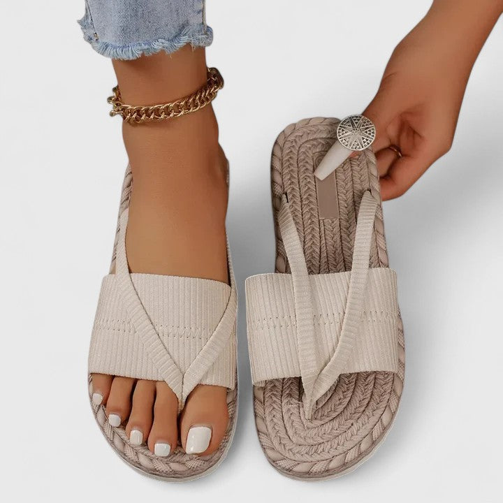 A woman moving freely in wide-fit open-front support sandals with a cushioned footbed.