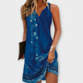 A flowing midi shirt dress in soft blue, styled casually for a summer day out