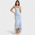 A romantic cream midi dress with square neckline and asymmetric hem, styled for a garden party