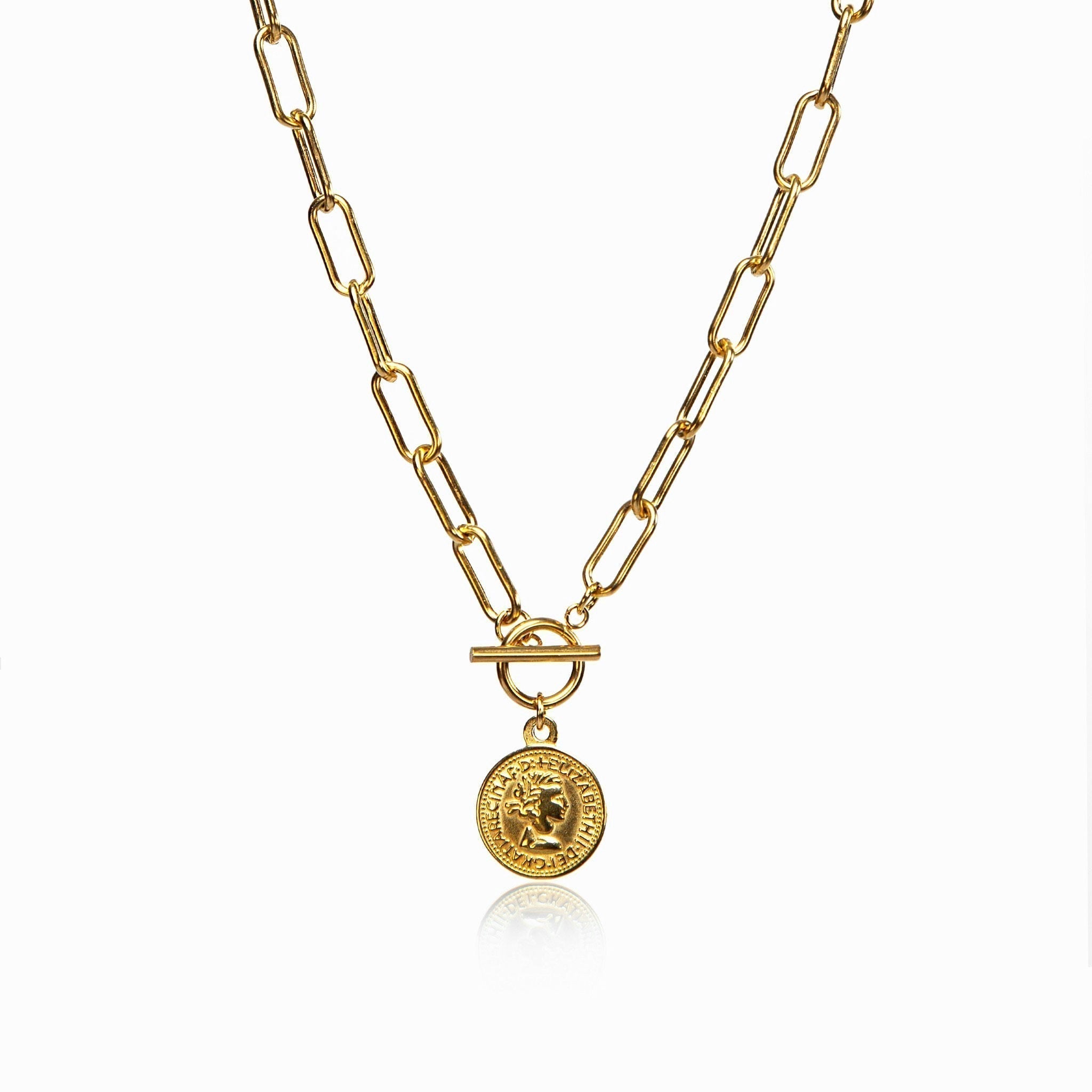 Delicate coin pendant necklace in gold tone on a white surface
