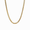 Gold Cuban-style pendant necklace on a white background