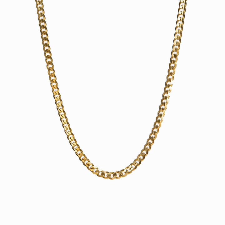 Gold Cuban-style pendant necklace on a white background