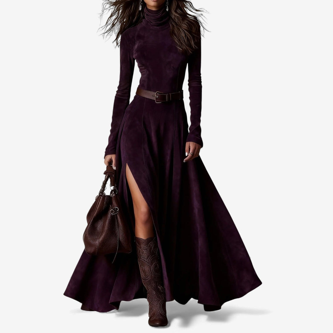 Woman wearing a long fluid maxi dress with a high neckline and a belt defining her waist.