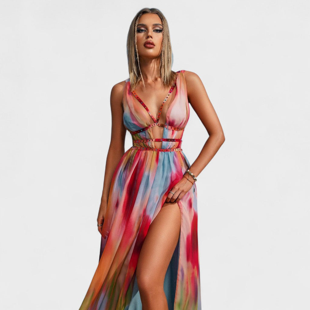A fluid printed summer dress in a vibrant artistic pattern, styled for an outdoor occasion