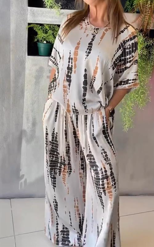 A woman wearing a vivid printed matching top and trousers set.