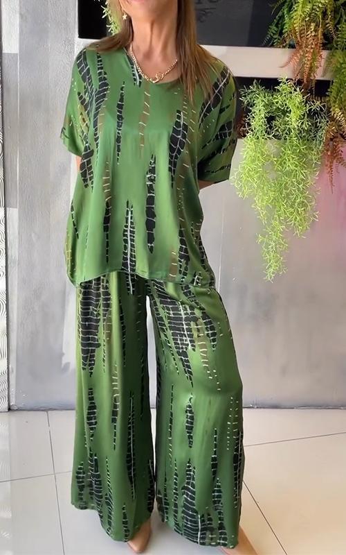 A woman wearing a vivid printed matching top and trousers set.