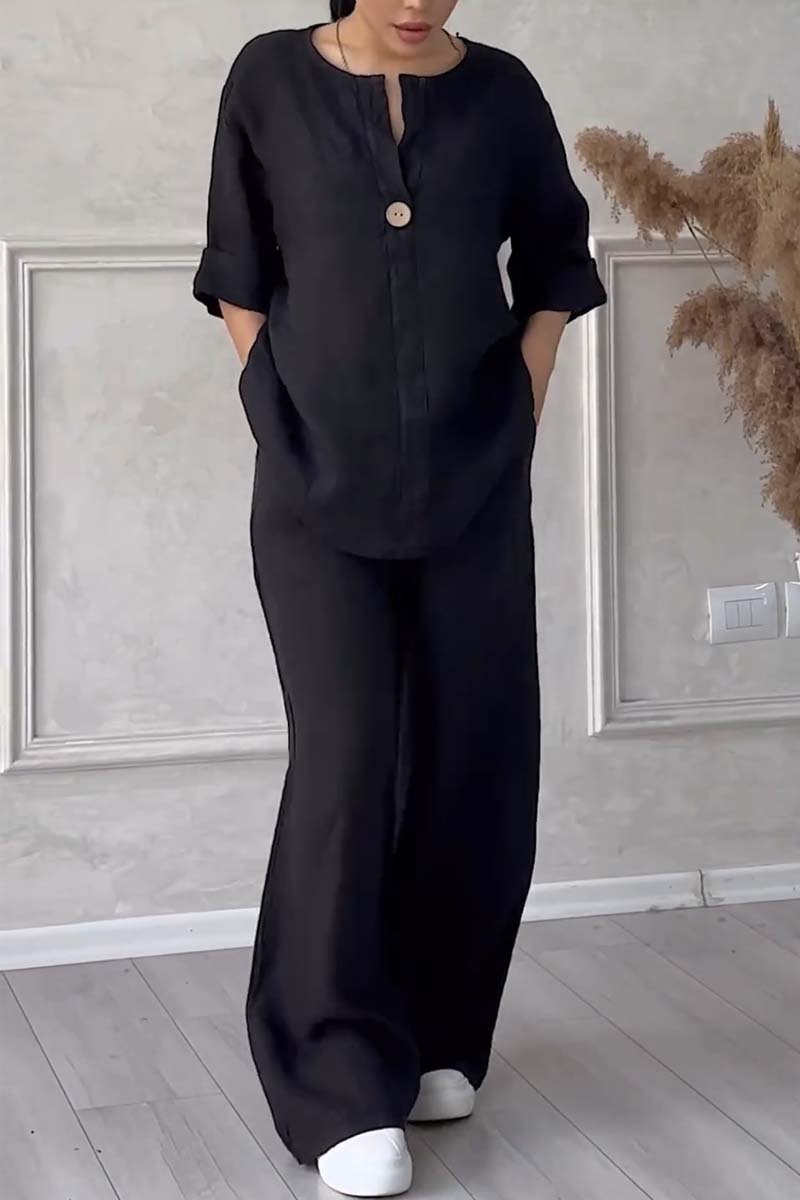 A woman wearing a loose relaxed top with matching wide-cut trousers.