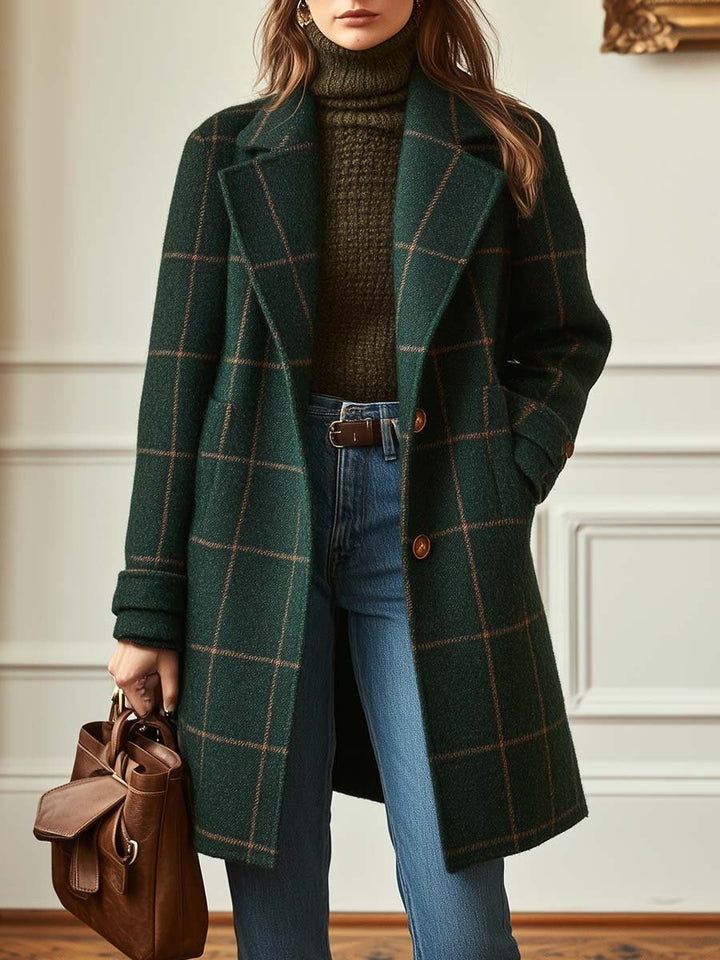 A woman wearing a classic checked belted coat in dark green with a defined waist.