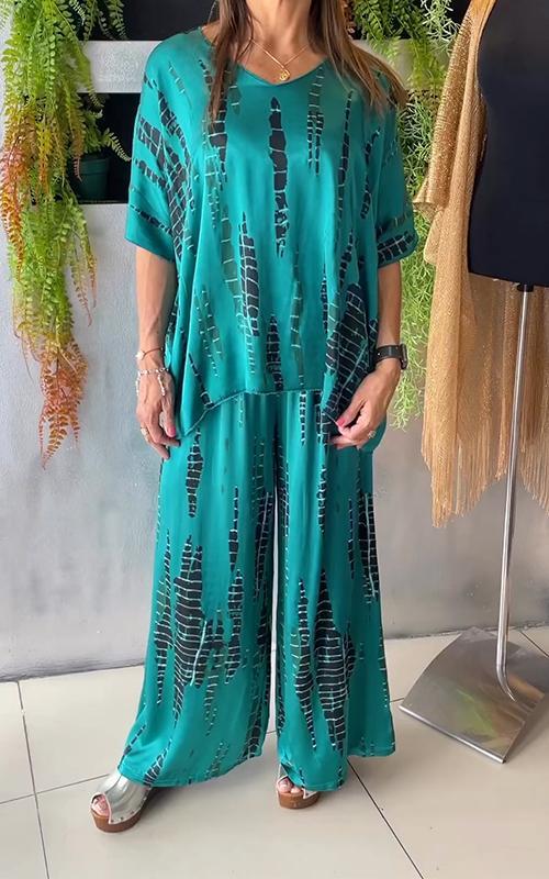 A woman wearing a vivid printed matching top and trousers set.